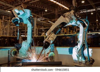 Industrial Robots Are Welding In Car Factory