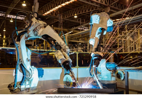 Industrial robots are\
welding in factory
