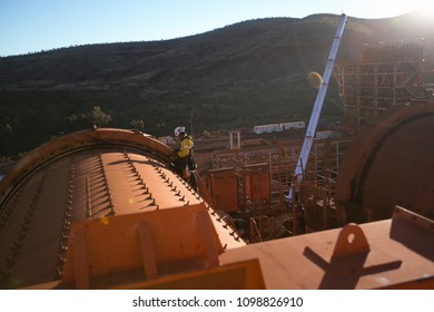Industrial rope access miner working at hight doing maintenance inspection on construction mine site Pilbara region 19/5/18  Perth, Western of Australian  