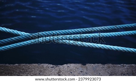 industrial ropes on water in the port