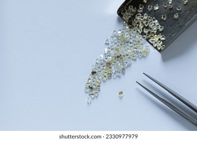 Industrial rough diamonds in the process of sorting at the workplace.