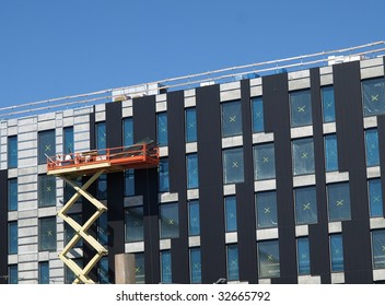 Industrial Scissor Lift In Use For Building Construction