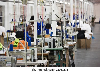 Industrial size textile factory in Africa, African workers on the production line - Powered by Shutterstock