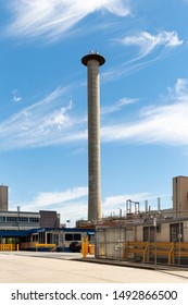 Industrial Smoke Stack Standing Tall Above Refinery Site.