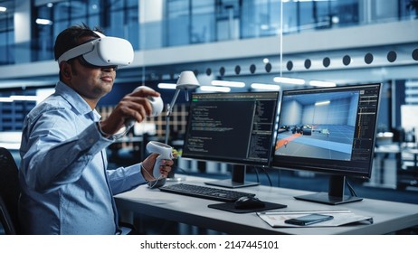 Industrial Software Developer Writing Code and Testing Automotive Manufacturing Interface. Engineer Editing Electric Motor and Car Chassis while Wearing Virtual Reality Headset and Using Controllers. - Powered by Shutterstock