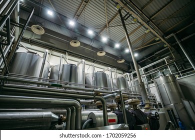 Industrial Stainless Steel Fermentation Vats In Modern Brewery