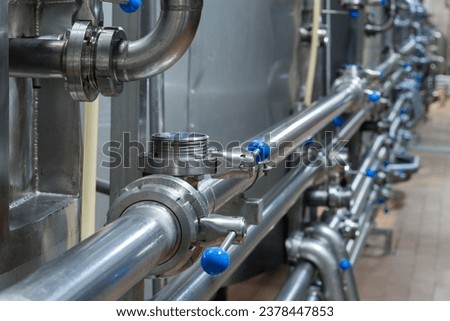 Industrial stainless steel pipework. Metal pipes, element of equipment design, of the milk production plant