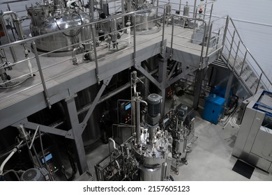 Industrial stainless steel vats. Factory interior, steel pipelines, tubes. Equipment for the production of organic fertilizers. Large reservoirs or tank - Powered by Shutterstock