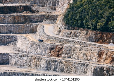 Industrial Stone Mining. Truck In The Middle Of Huge Quarry. 