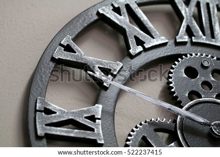 Industrial style wall clock with roman numbers on ten.