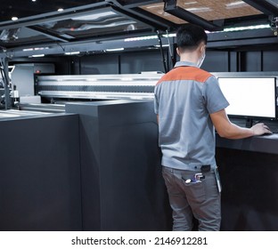 Industrial Technician Operating Corrugated Cardboard Digital Inkjet Printer. Printing Industry.