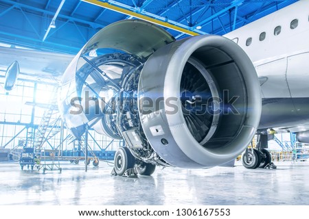 Industrial theme view. Repair and maintenance of aircraft engine on the wing of the aircraft