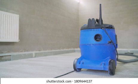 Industrial Vacuum Cleaner For Collecting Construction Dust And Debris. Professional Vacuum Cleaner After Work. Blue Construction Waste Collection Tank