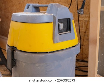 Industrial Vacuum Cleaner In A Small Woodworking Shop, Visible Dust On Every Corner Of The Shop.