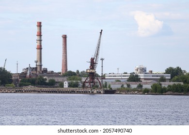 Industrial view of docks and multiple cranes on sea port. Photo taken on a warm summer overcast day.