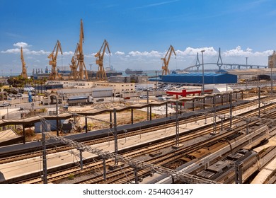 Industrial view of the port area in Cadiz with large cranes, railway tracks and the modern La Pepa Bridge, Spain - Powered by Shutterstock