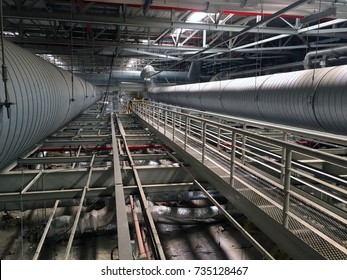 Industrial Walkway.
HVAC Duct Cleaning, Ventilation Pipes In Silver Insulation Material Hanging From The Ceiling.
