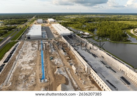 Industrial warehouse construction site. Assembling of metal and concrete frame of new logistics center in North Port, Florida