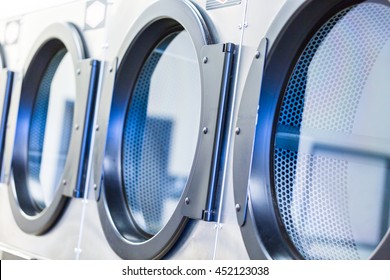 Industrial washing machines in a public laundromat.