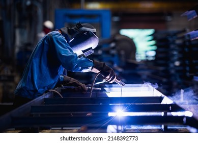 Industrial welder welding fabricated construction in factory, Welding process by Shielded Metal Arc Welding (SMAW) or Stick Welding. - Shutterstock ID 2148392773
