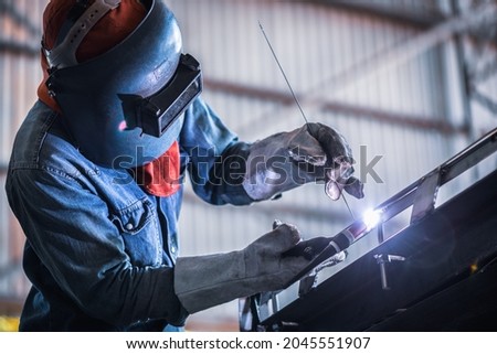 Industrial welder welding fabricated stainless construction work in factory, Welding process by Gas Tungsten Arc Welding - GTAW.