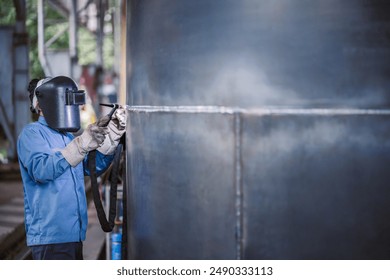 Industrial welder welding fabricated steel construction work in factory, Welding process by Gas Tungsten Arc Welding - GTAW. - Powered by Shutterstock