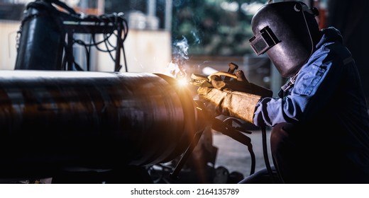 Industrial welder welding fabricated tube construction in factor - Shutterstock ID 2164135789