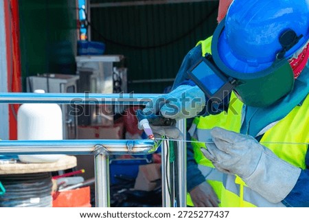Industrial welding and assembly process preparing equipment before installation in factory, representing manufacturing, heavy industry, engineering work, metal fabrication, construction preparation, industrial production, and technical craftsmanship.