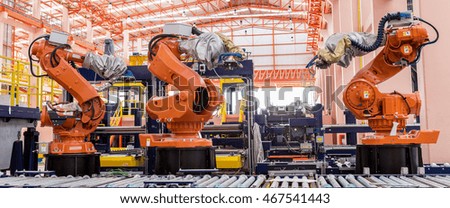 Industrial welding robots in production line manufacturer factory