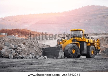 Industrial wheel loader loading ore on Open pit mine.