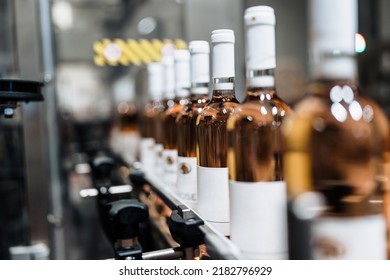 Industrial wine bottling plant theme. Modern industry production line for alcohol drink bottling and packaging.  - Powered by Shutterstock