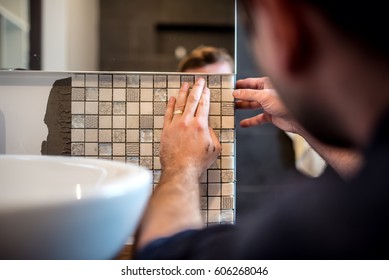 Industrial Worker Applying Mosaic Tiles In Bathroom Walls