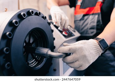 Industrial worker control cnc press for connection pipe with hydraulic hoses with fitting. - Powered by Shutterstock