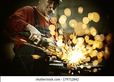 Industrial worker cutting and welding metal with many sharp sparks - Powered by Shutterstock