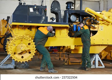 Industrial Worker During Heavy Industry Machinery Assembling On Production Line Manufacturing Workshop At Factory