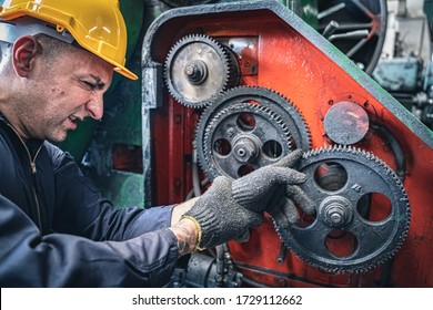 Industrial worker getting his finger stuck in the machine. Workplace accident.