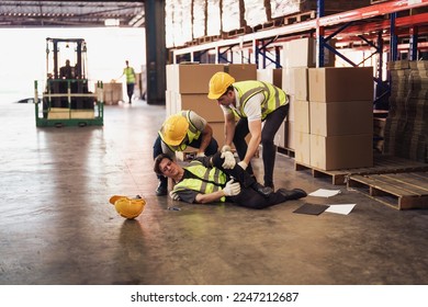 Industrial worker injured in the warehouse, factory while co-worker try to help, factory safety, construction zone, accident at factory work. - Powered by Shutterstock