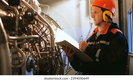 Industrial worker inspects turbine pre-engine start in industrial setting. Showcases industrial workers focus on safety, efficiency. Ideal for highlighting an industrial workers expertise. - Powered by Shutterstock