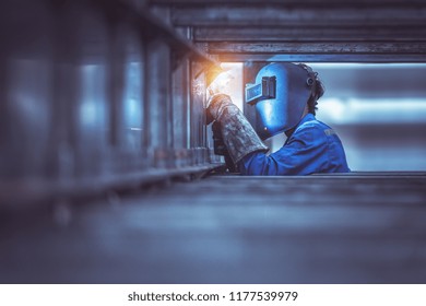 Industrial Worker labourer at the factory welding steel structure - Powered by Shutterstock
