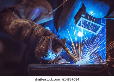 Industrial Worker labourer at the factory welding steel structure - Shutterstock ID 614869034