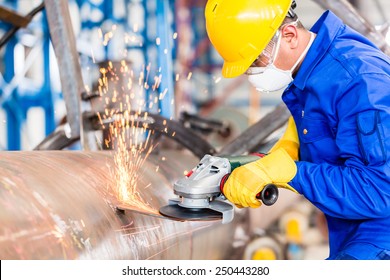 Industrial Worker In Manufacturing Plant Grinding To Finish A Pipeline