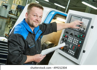 Industrial Worker Operating Cnc Turning Machine In Metal Machining Industry