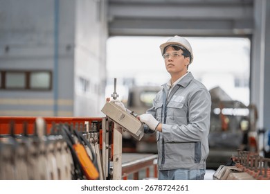 Industrial worker operating control panel in a factory setting machinery environment focused action