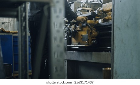 Industrial worker operating a lathe machine, skillfully shaping metal in a factory workshop, emphasizing precision and the intricate manufacturing processes involved in metalworking
