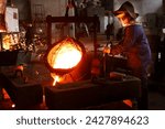 Industrial worker pours molten metal at foundry. Steel production in heat-resistant suit, helmet. Heavy industry labor. Metallurgy process, smelting iron in blast furnace. Metalwork, hot iron casting.