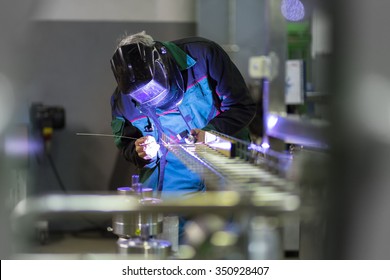 Industrial Worker With Protective Mask Welding Inox Elements In Steel Structures Manufacture Workshop.