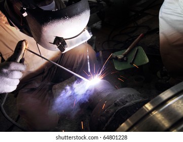 industrial worker welding sparking
