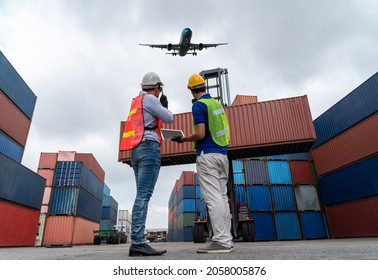 Industrial worker works and co  worker at overseas shipping container port   Logistics supply chain management   international goods export concept  