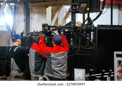 Industrial Workers Assembles Agricultural Machinery In Workshop