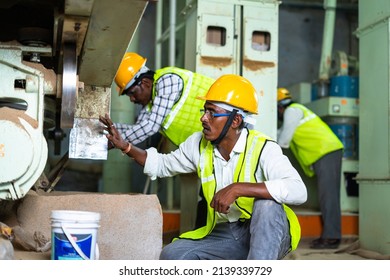 Industrial Workers Busy Working On Machinery With Safety Helmet At Factory - Concept Of Blue Collar Jobs, Teamwork And Occupation